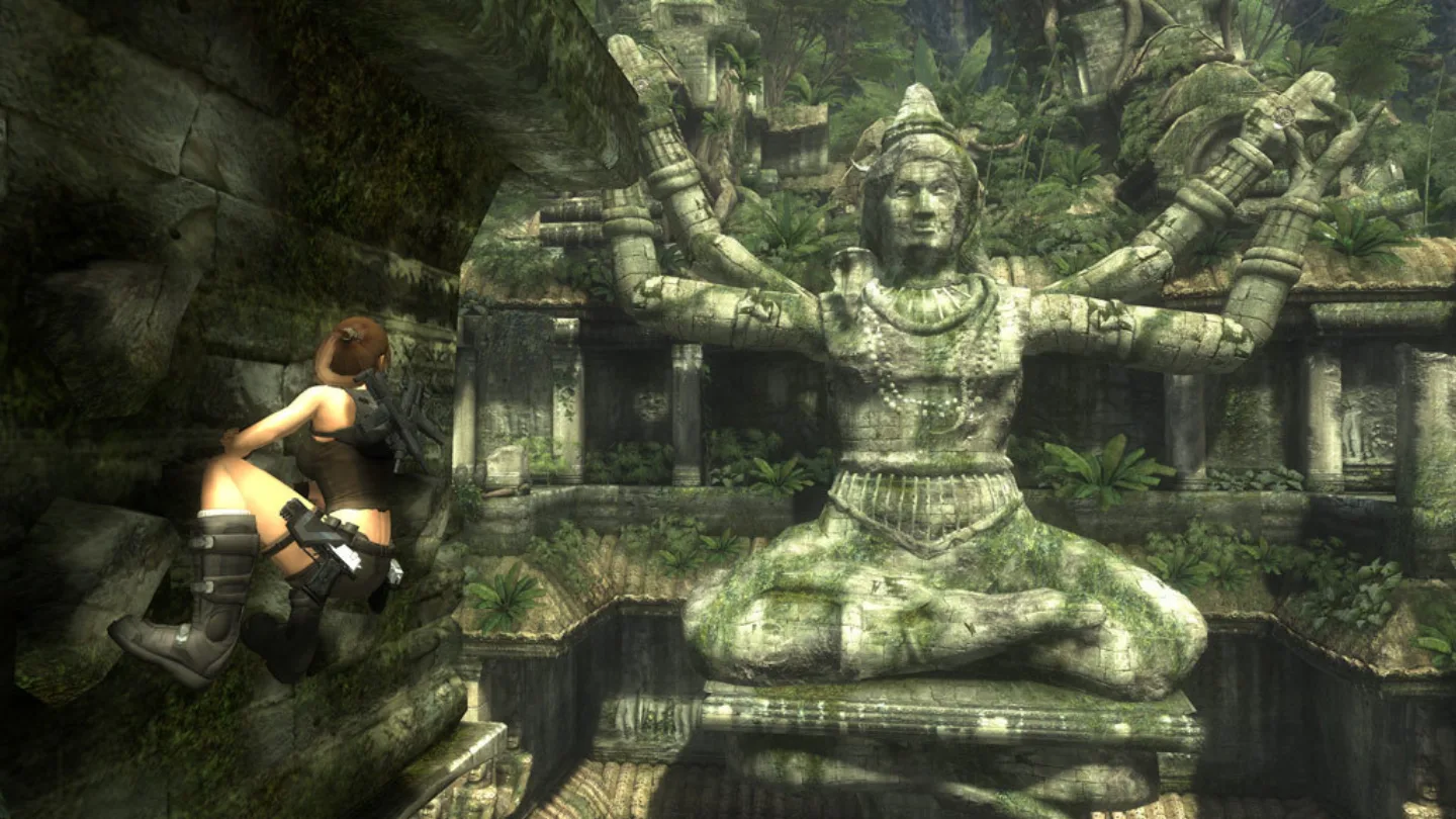 Lara Croft climbing a giant temple statue in Tomb Raider: Underworld's Thailand level