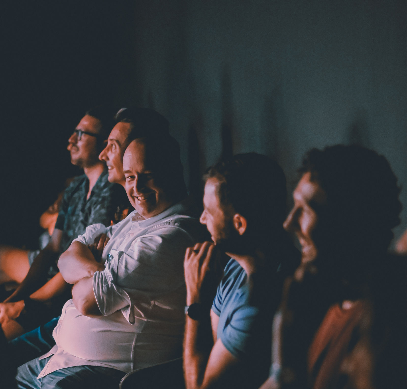 A Bangkok comedy audience mid-laugh