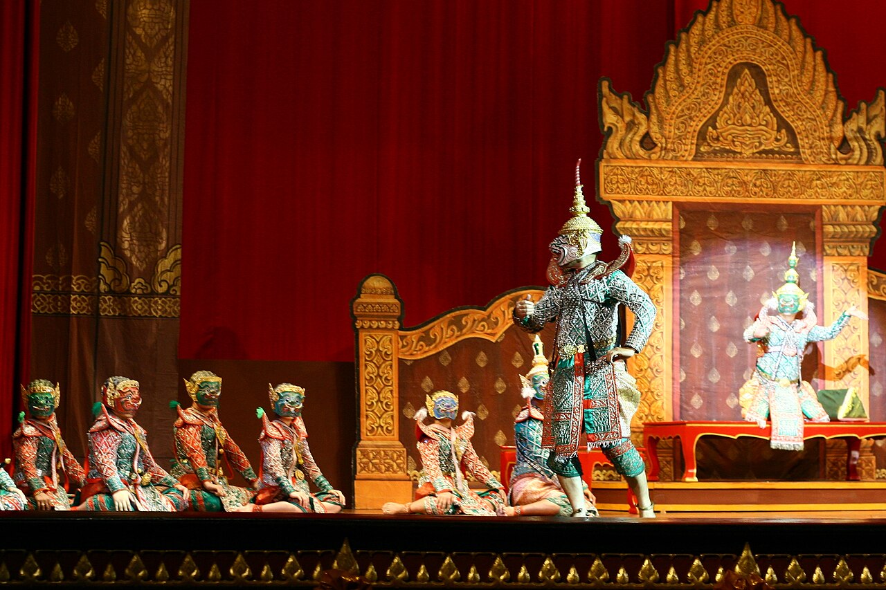 Masked Khon performers in jewelled costumes on a gilded stage in Bangkok