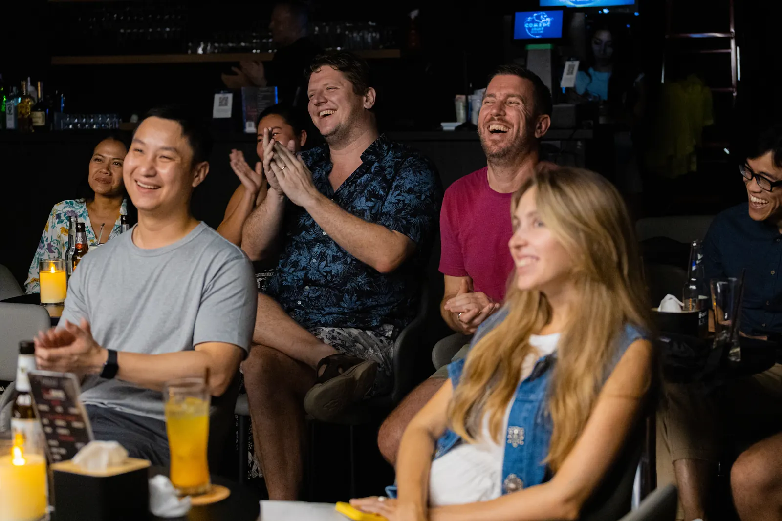 A happy crowd laughing at The Comedy Joint