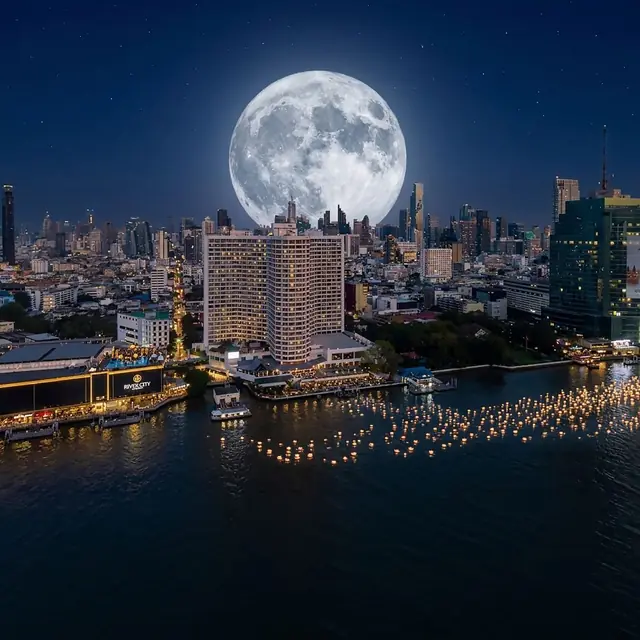 Krathong on the river below a huge full moon