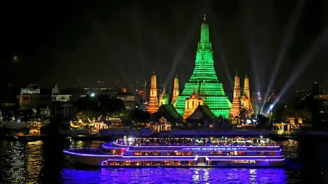 White Orchid passing Wat Arun at night