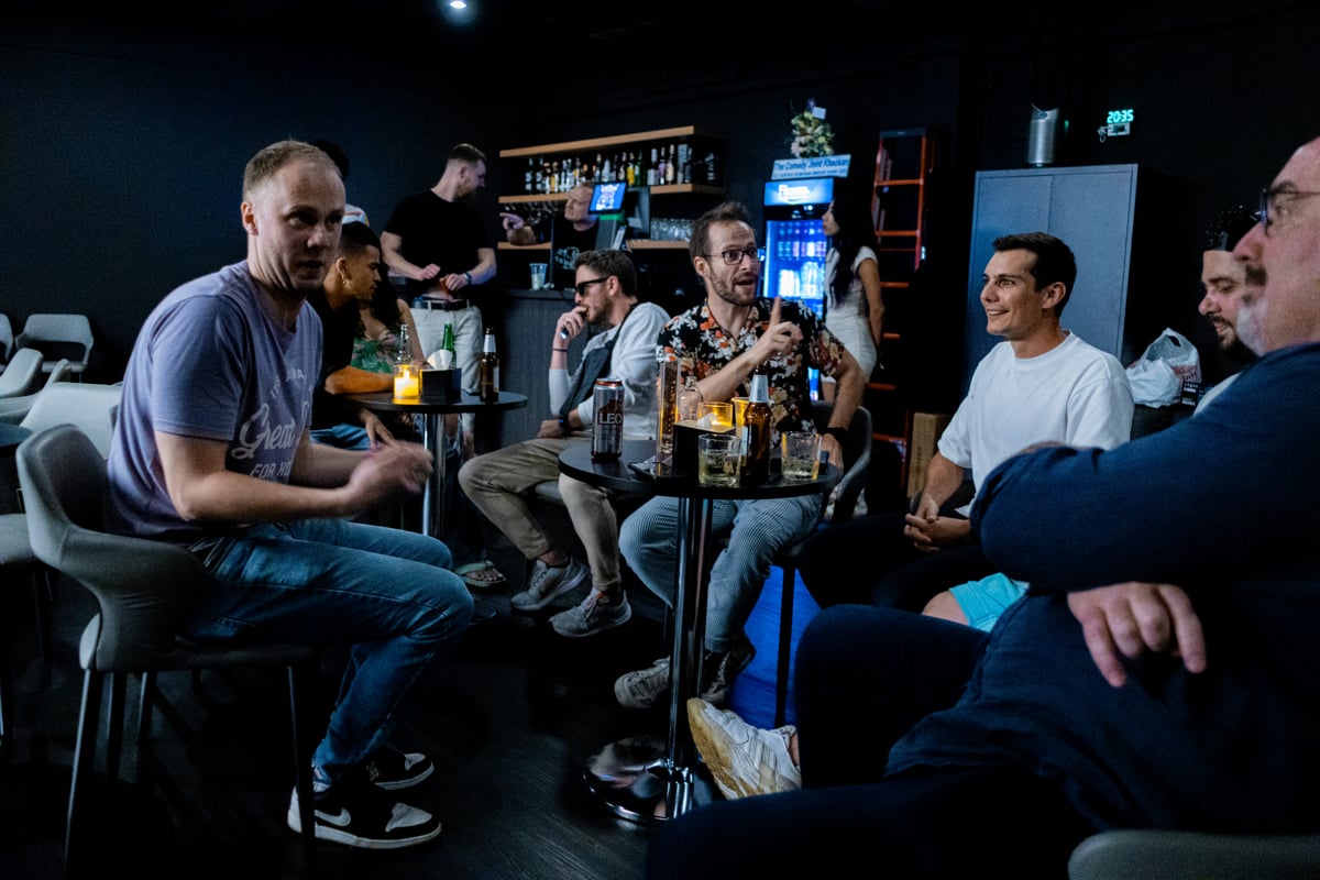 Stand-up comedians chatting together at a Bangkok bar
