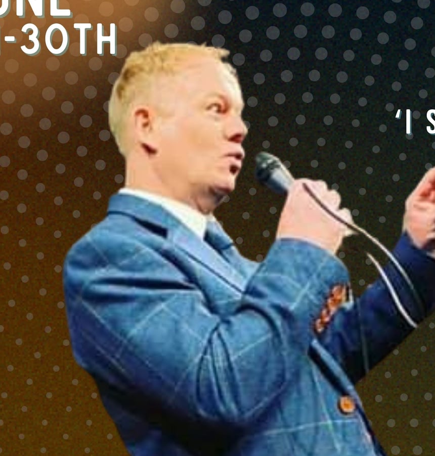 Ian Harvey Stone performing with a microphone