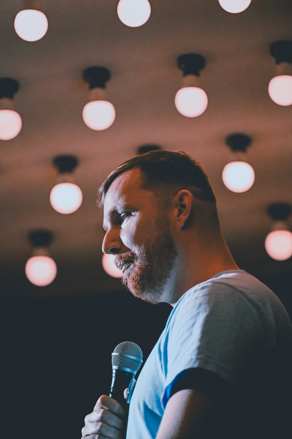 A stand-up comic holding a microphone in Bangkok