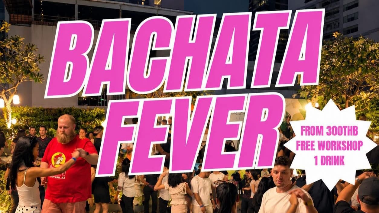 Dancers in couples across a rooftop floor at Bachata Fever on a Sunday night in Bangkok