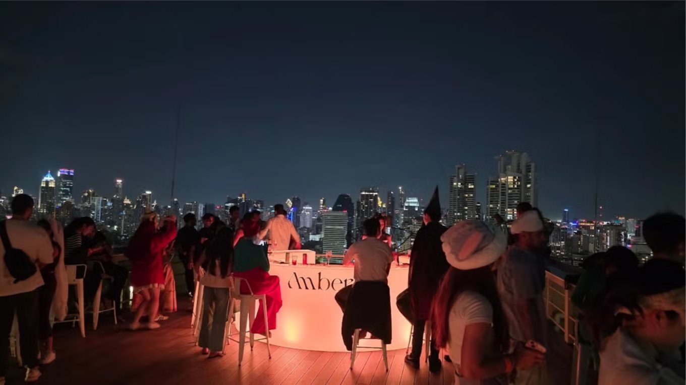 A Bangkok Digital Nomads meetup at Amber Bar on the 34th floor of the Wyndham, Asok, with the city skyline behind