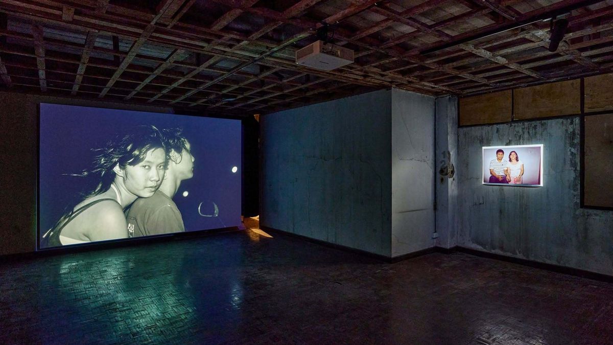 A film projected on the wall of Bangkok Kunsthalle's bare concrete screening room, under the old printing house's exposed ceiling