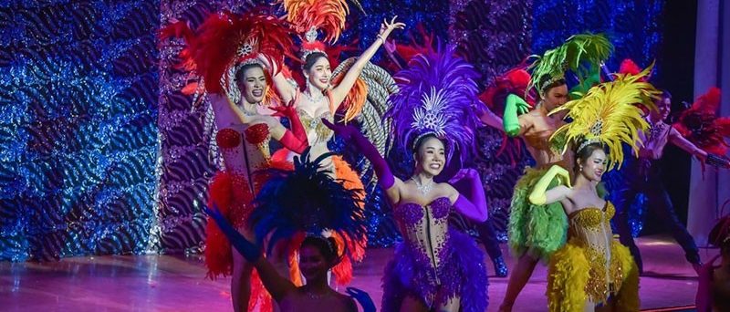 Golden Dome Cabaret’s cast in feathered costumes for the finale