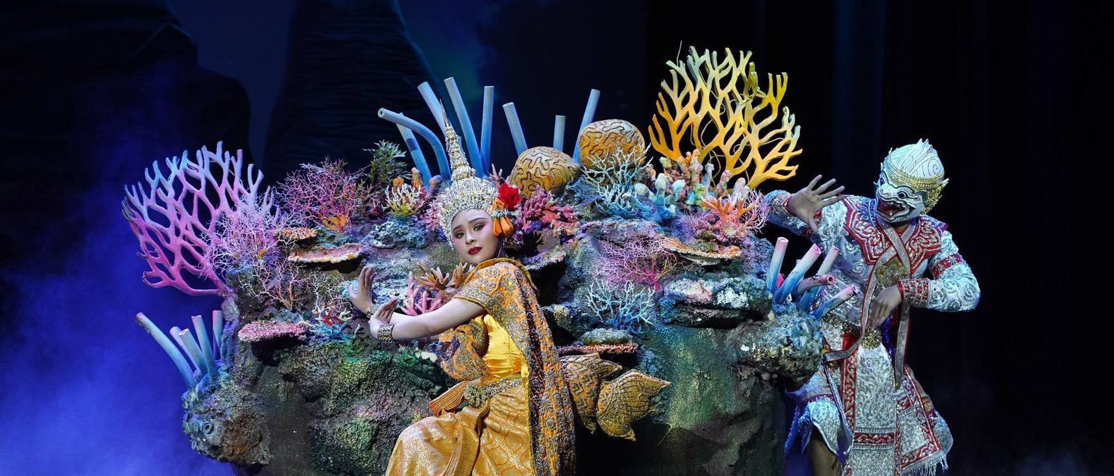 Khon performers in jewelled costumes among a coral-reef set at Sala Chalermkrung