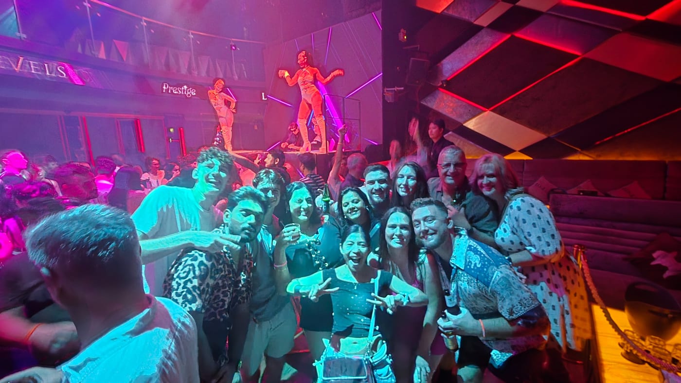Intoxicate Bangkok's group on the dance floor at Levels, with dancers on a stage behind them