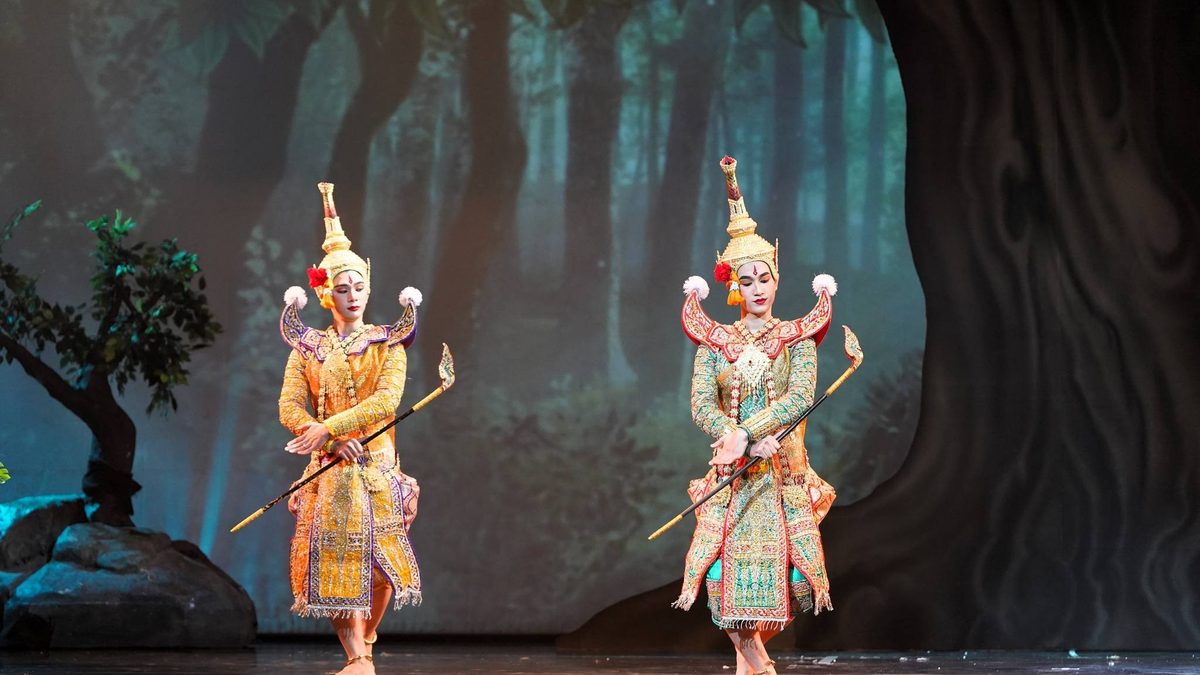 Two Khon performers in gold costumes on the Sala Chalermkrung stage
