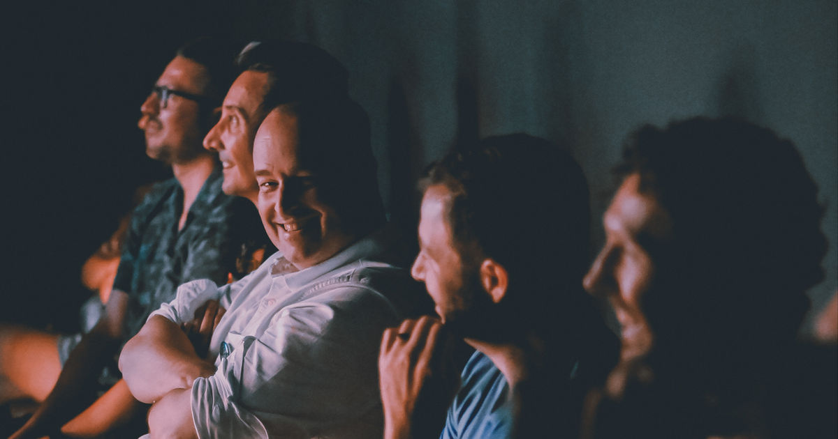 A Bangkok comedy audience mid-laugh